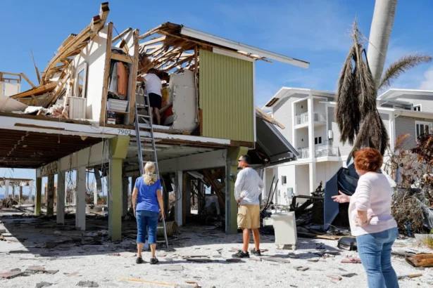 A Florida homeowner looking at rising insurance bills with concern, highlighting the state's ongoing insurance crisis.